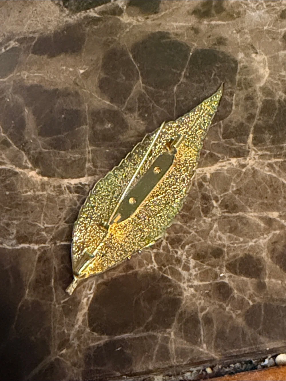 Beautiful gold plated leaf with a cabochon opal and crystal surrounding